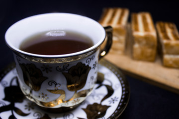 toast with chocolate sprinkles and tea to accompany relaxing time with a black background