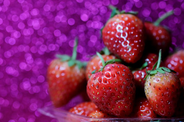 Strawberry on glitter violet background and have space for write wording, sweet romantic fruit for special person, lovers in Valentine day, make many dessert menu or juice or dairy strawberry flavor