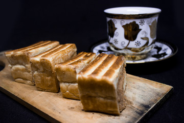 toast with chocolate sprinkles and tea to accompany relaxing time with a black background