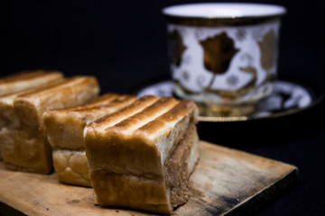 toast with chocolate sprinkles and tea to accompany relaxing time with a black background