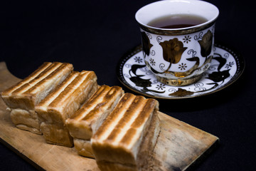 toast with chocolate sprinkles and tea to accompany relaxing time with a black background
