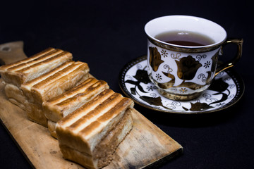 toast with chocolate sprinkles and tea to accompany relaxing time with a black background