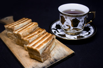 toast with chocolate sprinkles and tea to accompany relaxing time with a black background