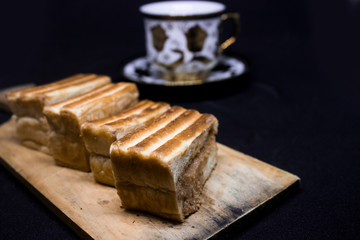 toast with chocolate sprinkles and tea to accompany relaxing time with a black background