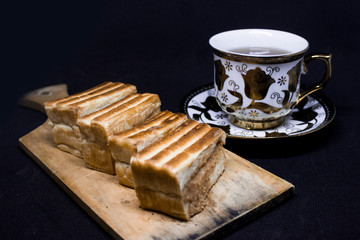 toast with chocolate sprinkles and tea to accompany relaxing time with a black background