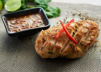 Grilled chicken breast on a wooden board