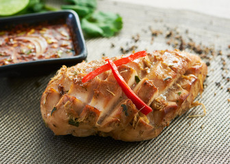 Grilled chicken breast on a wooden board