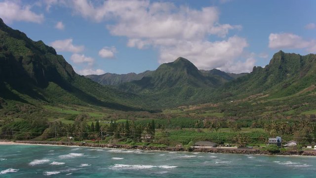 Oahu, Hawaii circa-2018.  Aerial approach from ocean to Kaaawa Valley.  Shot with Cineflex and RED Epic-W Helium. 