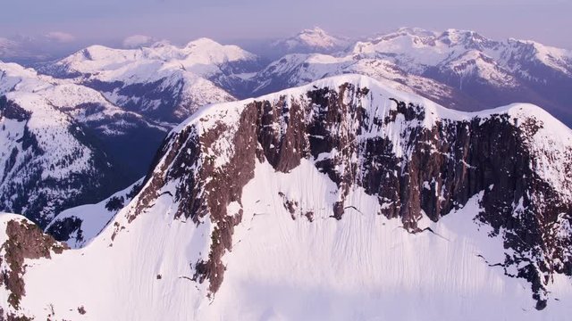 British Columbia, Canada circa-2018. Aerial view of snow covered mountain range.  Shot from helicopter with Cineflex gimbal and RED Epic-W camera.
