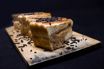 toast with chocolate sprinkles and tea to accompany relaxing time with a black background