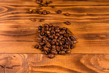 Pile of the coffee beans on wooden table