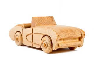 Photo of the a retro cars cabriolet of beech. Toy made of wood on a white isolated background