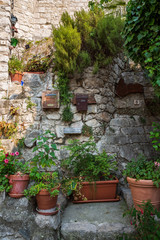 Fototapeta na wymiar Peillon France July 7th 2015 : Pots and flower arrangements in the beautiful hilltop village of Peillon in the Alpes-Maritime department of southeastern France