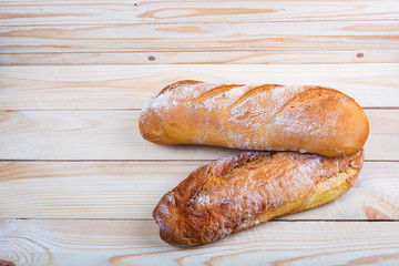 Fresh bread on rustic wooden table with copy space for your text