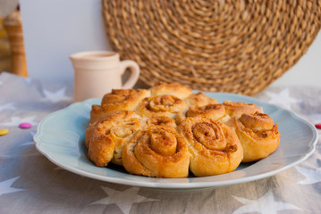 Homemade cinnamon roll pie on holiday towel with stars. Food rustic background.