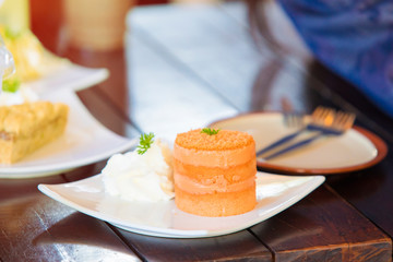 Orange Cake in white dish on the wood table