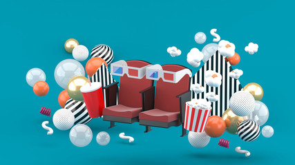 Cinema chair Soft drinks and popcorn among the colorful balls on the blue background.-3d rendering.