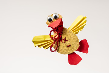 A colorful flying duck made of paper by a child