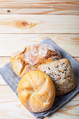 Fresh bread on rustic wooden table with copy space for your text