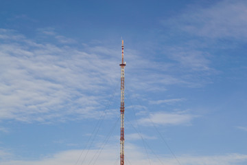 Antenna in the blue sky. Tower in the sky.	