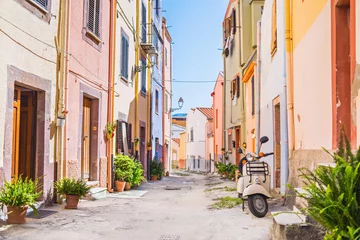  Old-fashioned scooter in a picturesque street of tiny Bosa town, Sardinia island © kite_rin