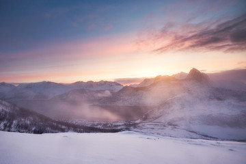 Fototapeta na wymiar Colorful sunrise on snowy mountain