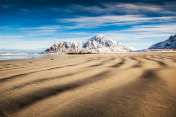 Fototapeta na wymiar Natural furrow sand with snow mountain and blue sky