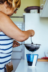 Woman cooking blackberry jam