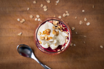 looking down on glass of stewed plums with oats and custard