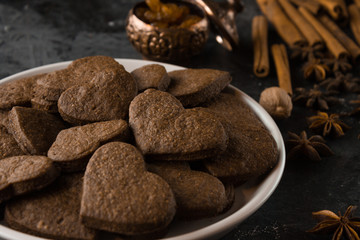 Vegan heart gingerbread cookies on dark background