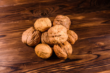 Pile of walnuts on a wooden table