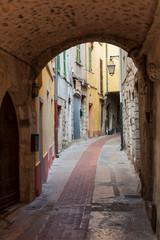 View of the narrow streets with archways in Peille, southeastern France