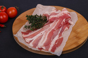 Raw bacon on the board