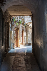 View of the narrow streets with archways in Peille, southeastern France