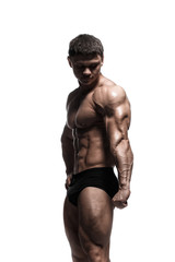 Handsome power athletic man pumping up muscles isolated over white. Strong bodybuilder with perfect...