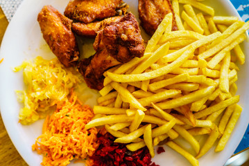 Chicken wings, french fries and salad