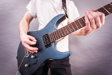 Obraz na płótnie Canvas Close up of man playing on electric guitar