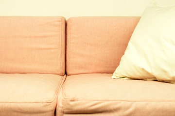 Pink sofa front view, close-up, comfort concept