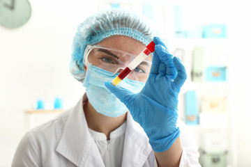 Fototapeta premium Woman working with blood sample in laboratory