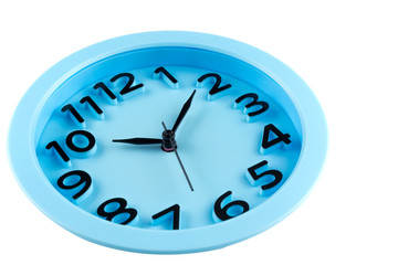 Close-up of the blue clock face with three-dimensional numbers. Focus on center.