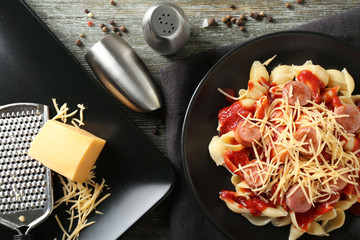 Delicious pasta with sausage and sauce on plate