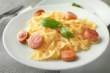 Delicious pasta with sausage on plate