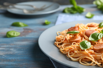 Delicious pasta with sausage on plate