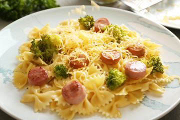 Delicious pasta with sausage on plate, closeup