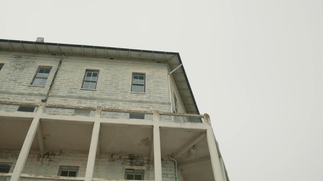 Corner wall of Alcatraz prison building, low angle moving shot