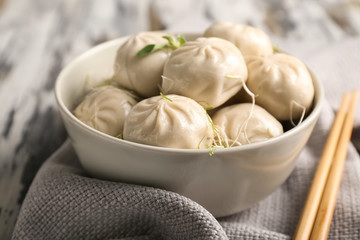 Bowl with tasty Chinese dumplings on table