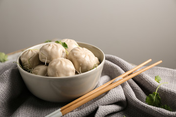 Bowl with tasty Chinese dumplings on table