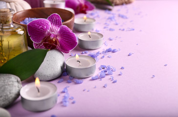 Beautiful spa composition with burning candles on color background