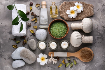 Beautiful spa composition with candles, cosmetics and accessories on grey background