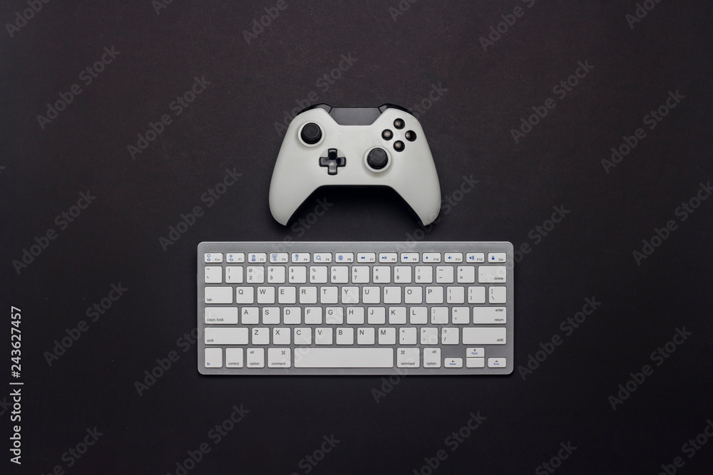 Wall mural white gamepad and keyboard on a black background. tactics of the game. concept game on the console a